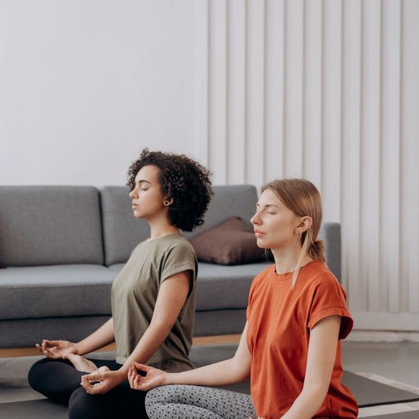 Person in a serene yoga pose in a bright, minimalist room.